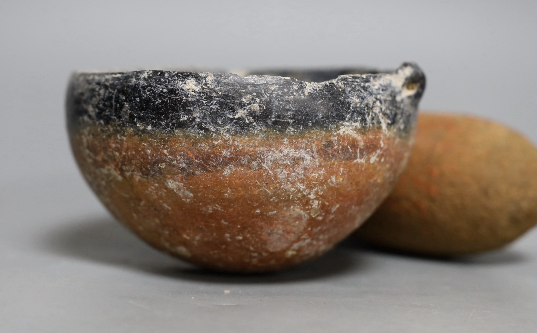 An ancient Egyptian vessel c.1400 BC, together with an ancient black-top bowl, possibly from the early Bronze Age, 14cm diameter, (2)